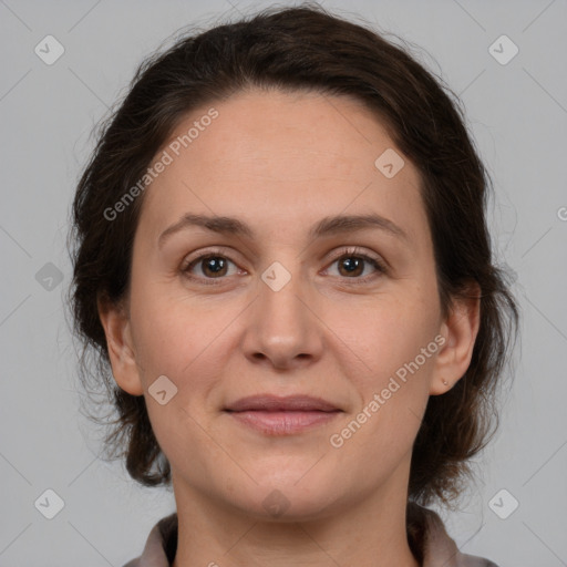 Joyful white adult female with medium  brown hair and brown eyes