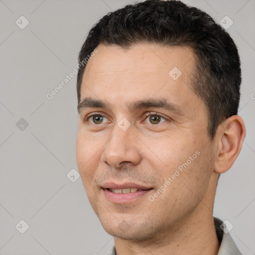 Joyful white adult male with short  brown hair and brown eyes