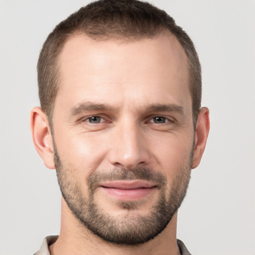 Joyful white young-adult male with short  brown hair and brown eyes