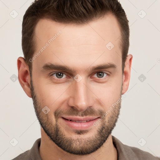 Joyful white young-adult male with short  brown hair and grey eyes