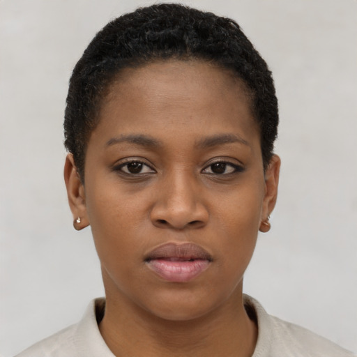 Joyful black young-adult female with short  brown hair and brown eyes