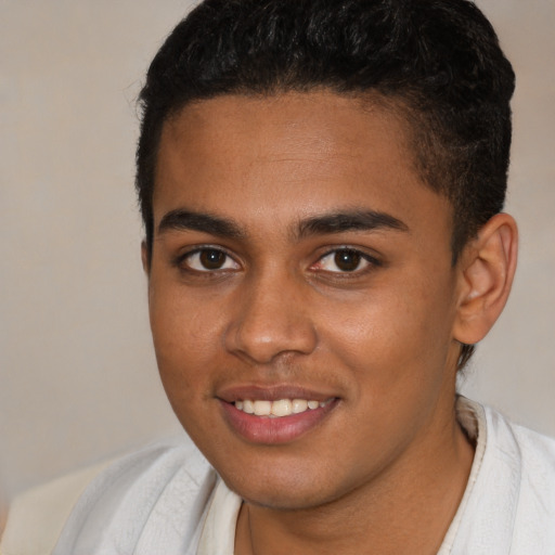 Joyful black young-adult male with short  brown hair and brown eyes