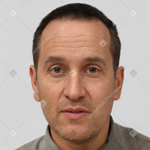 Joyful white adult male with short  brown hair and brown eyes