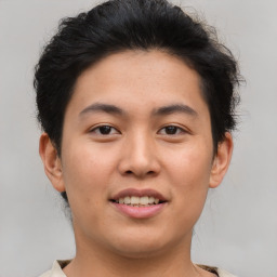 Joyful asian young-adult male with short  brown hair and brown eyes