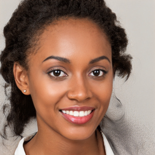 Joyful black young-adult female with medium  brown hair and brown eyes