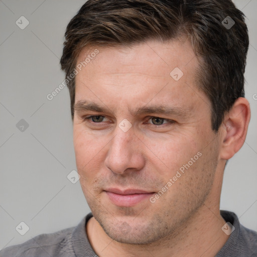 Joyful white adult male with short  brown hair and brown eyes