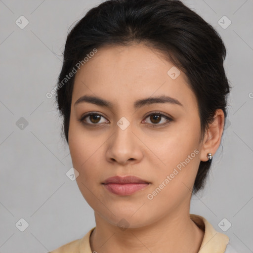 Joyful latino young-adult female with medium  brown hair and brown eyes