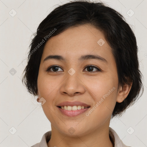 Joyful latino young-adult female with medium  brown hair and brown eyes