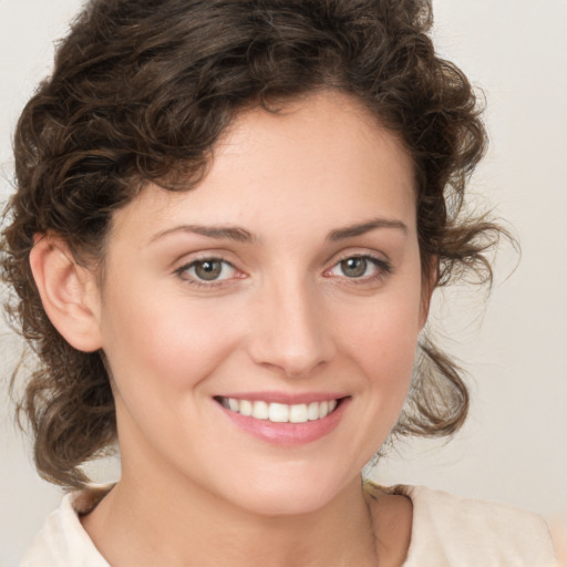 Joyful white young-adult female with medium  brown hair and green eyes