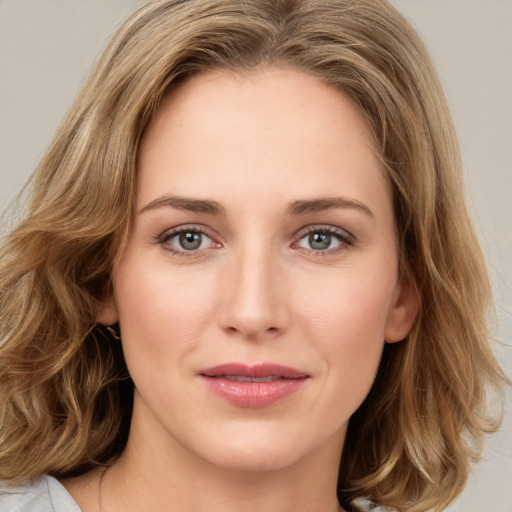 Joyful white young-adult female with medium  brown hair and green eyes