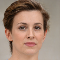 Joyful white young-adult female with medium  brown hair and green eyes