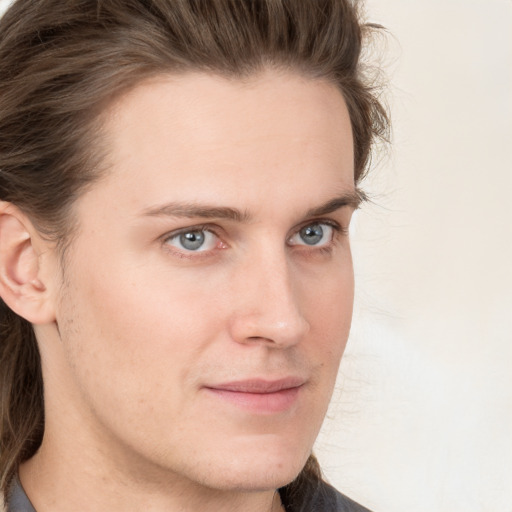 Joyful white young-adult male with medium  brown hair and grey eyes