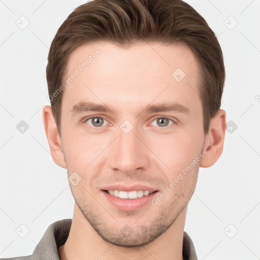 Joyful white young-adult male with short  brown hair and grey eyes