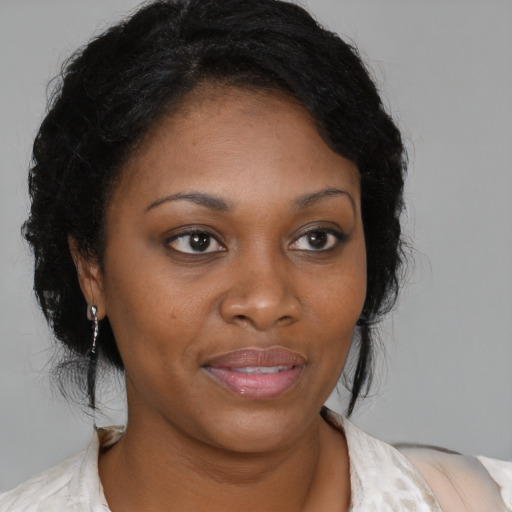Joyful black young-adult female with medium  brown hair and brown eyes