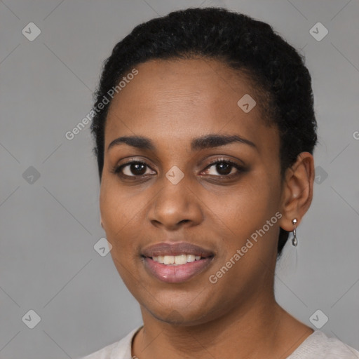 Joyful black young-adult female with short  black hair and brown eyes