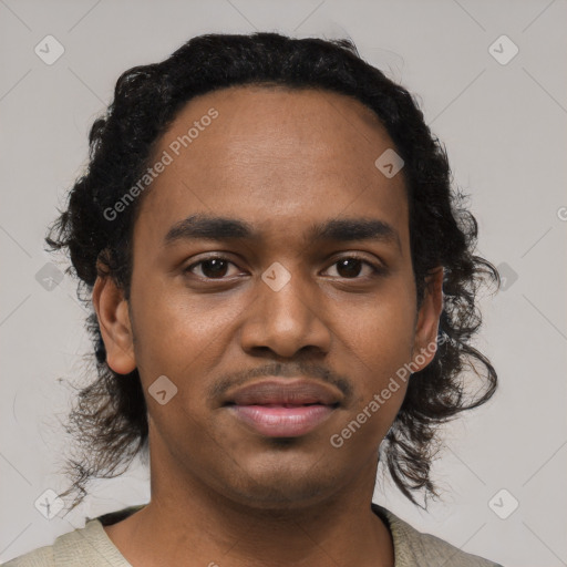 Joyful black young-adult male with short  black hair and brown eyes