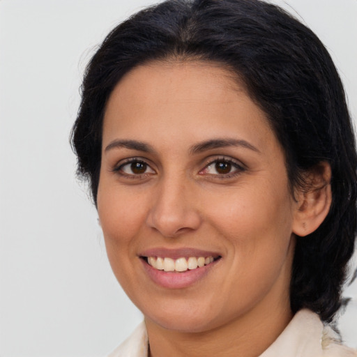 Joyful latino young-adult female with medium  brown hair and brown eyes