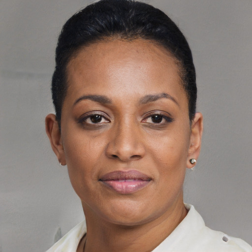 Joyful black adult female with short  black hair and brown eyes