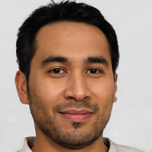 Joyful latino young-adult male with short  brown hair and brown eyes