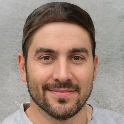 Joyful white young-adult male with short  brown hair and brown eyes