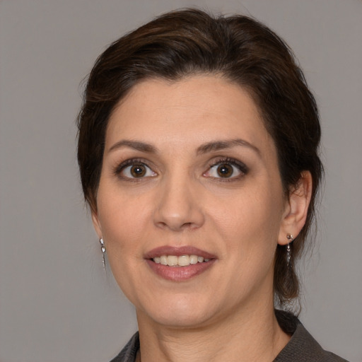 Joyful white adult female with medium  brown hair and brown eyes