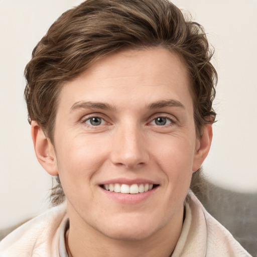 Joyful white young-adult female with short  brown hair and grey eyes