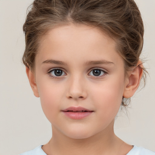 Joyful white child female with short  brown hair and brown eyes