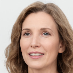 Joyful white adult female with long  brown hair and grey eyes