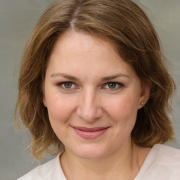 Joyful white young-adult female with medium  brown hair and green eyes