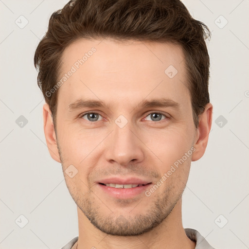 Joyful white young-adult male with short  brown hair and grey eyes