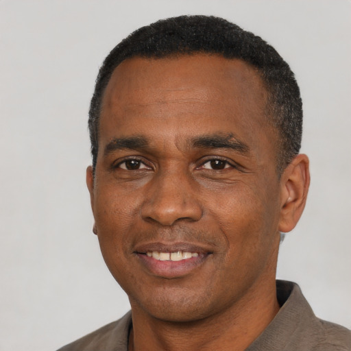 Joyful latino adult male with short  black hair and brown eyes