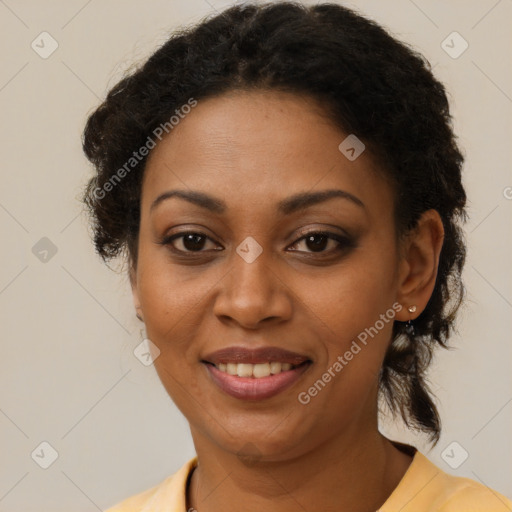 Joyful black adult female with medium  brown hair and brown eyes