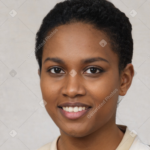 Joyful black young-adult female with short  black hair and brown eyes