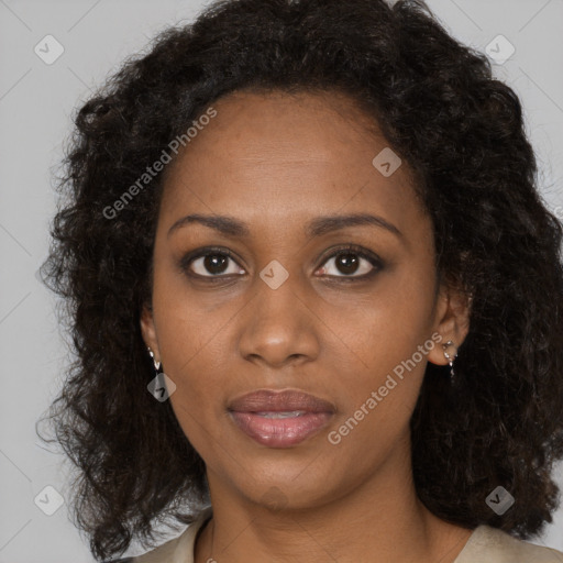 Joyful black young-adult female with long  brown hair and brown eyes