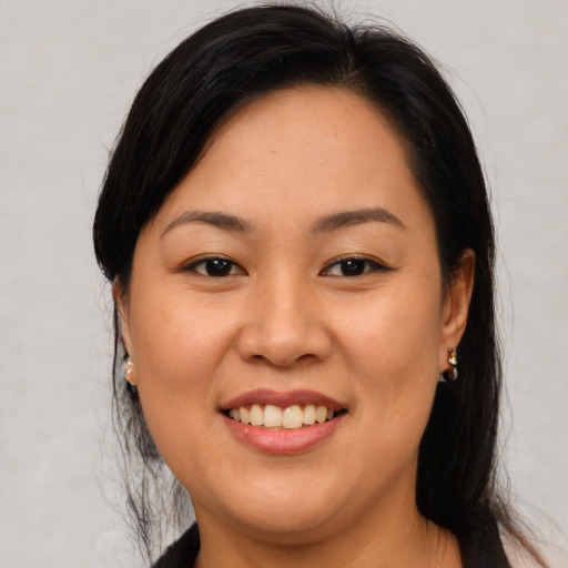 Joyful asian young-adult female with medium  brown hair and brown eyes