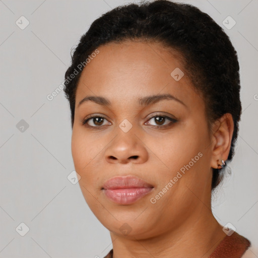 Joyful black young-adult female with short  brown hair and brown eyes