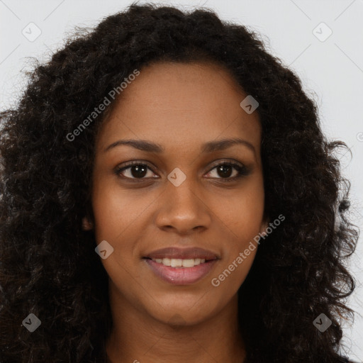 Joyful black young-adult female with long  brown hair and brown eyes