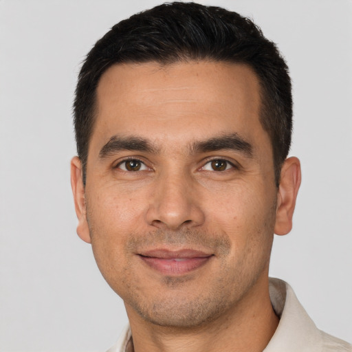 Joyful white adult male with short  brown hair and brown eyes