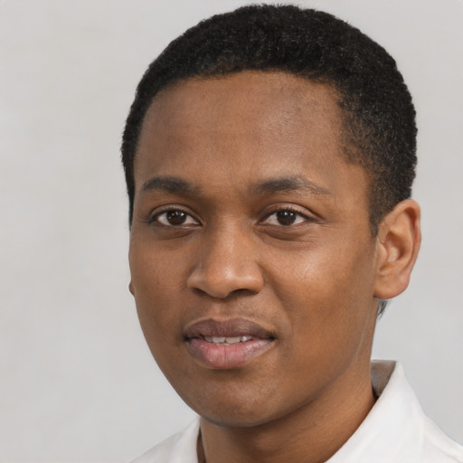 Joyful black young-adult male with short  black hair and brown eyes