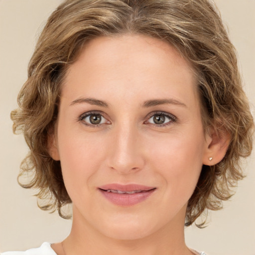 Joyful white young-adult female with medium  brown hair and green eyes