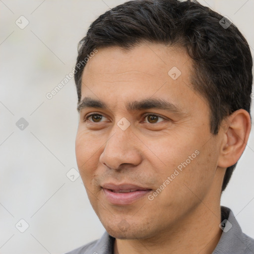 Joyful white young-adult male with short  black hair and brown eyes