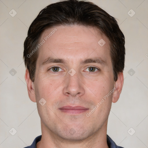 Joyful white adult male with short  brown hair and grey eyes