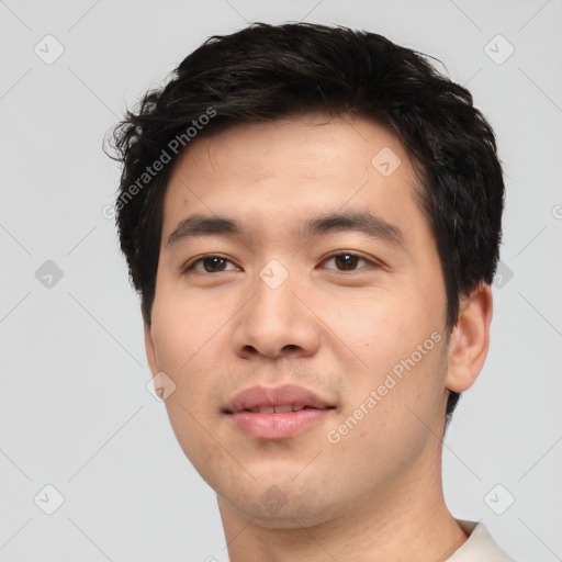 Joyful asian young-adult male with short  black hair and brown eyes