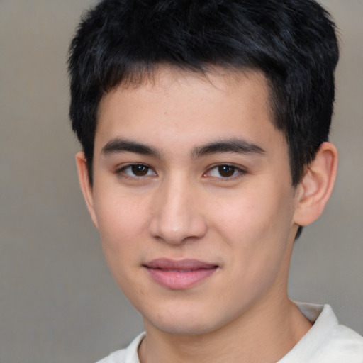 Joyful asian young-adult male with short  brown hair and brown eyes