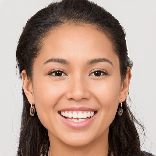 Joyful white young-adult female with long  brown hair and brown eyes