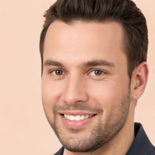 Joyful white young-adult male with short  brown hair and brown eyes