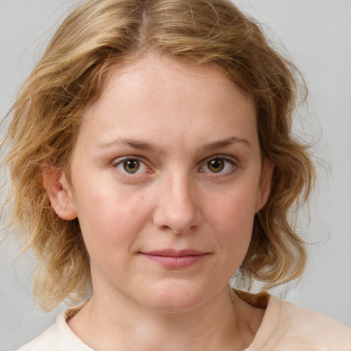 Joyful white young-adult female with medium  brown hair and blue eyes