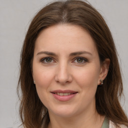 Joyful white young-adult female with medium  brown hair and green eyes