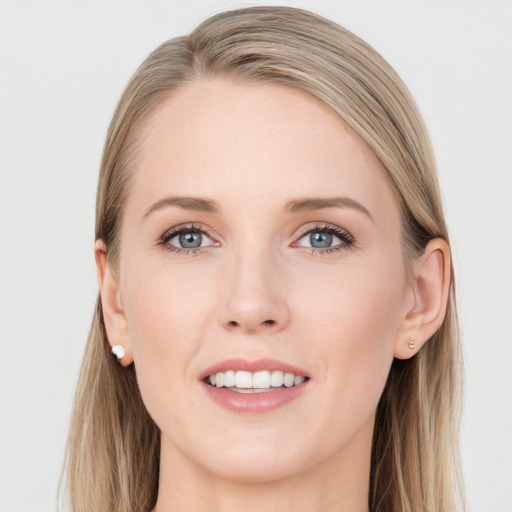 Joyful white young-adult female with long  brown hair and blue eyes