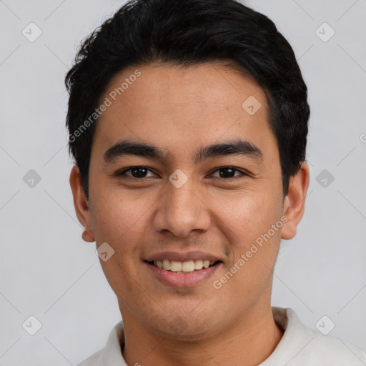 Joyful latino young-adult male with short  black hair and brown eyes